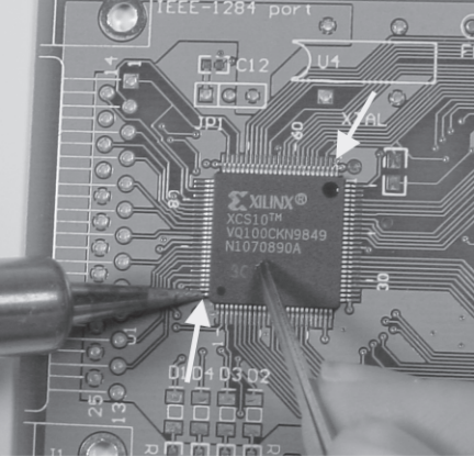 Figure B-2: Soldering one pin on each of two opposite corners to tack chip in place