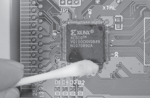 Figure B-6: Cleaning flux residue with cotton swab